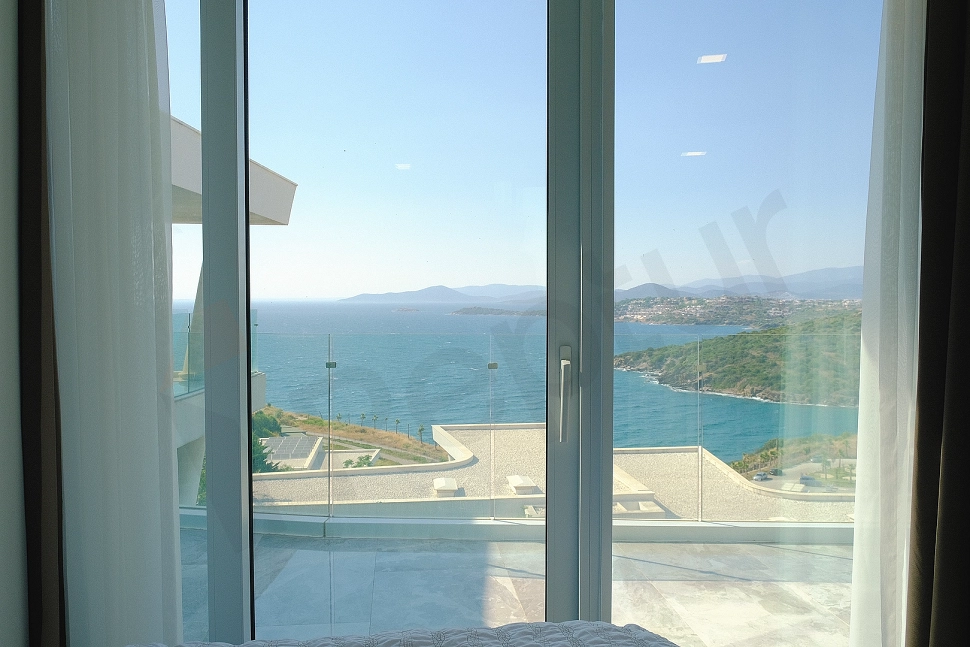 Outdoor view showing a vast sea or bay, with a clear blue sky and a wide horizon.