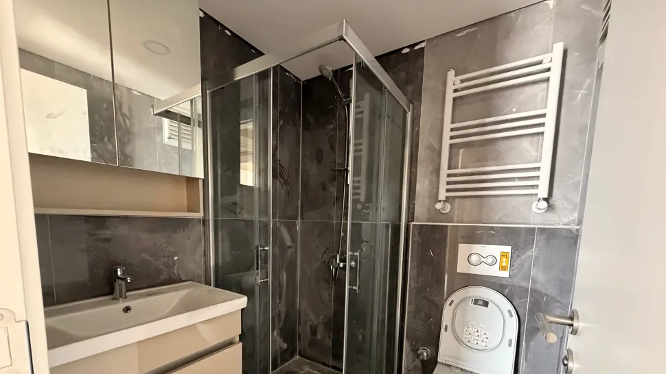 A spacious bathroom image with modern design, stylish ceramics, and sanitary ware in a new building.
