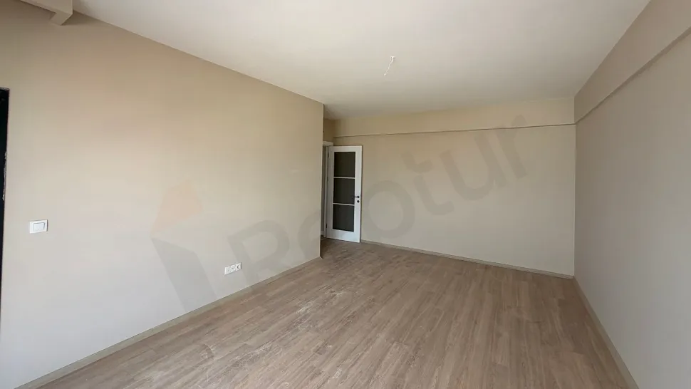 Bright living room area with large windows and city views in a modern apartment in Pendik.