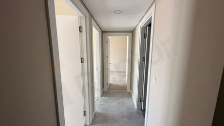 Spacious and bright interior corridor view of a modern residence building.