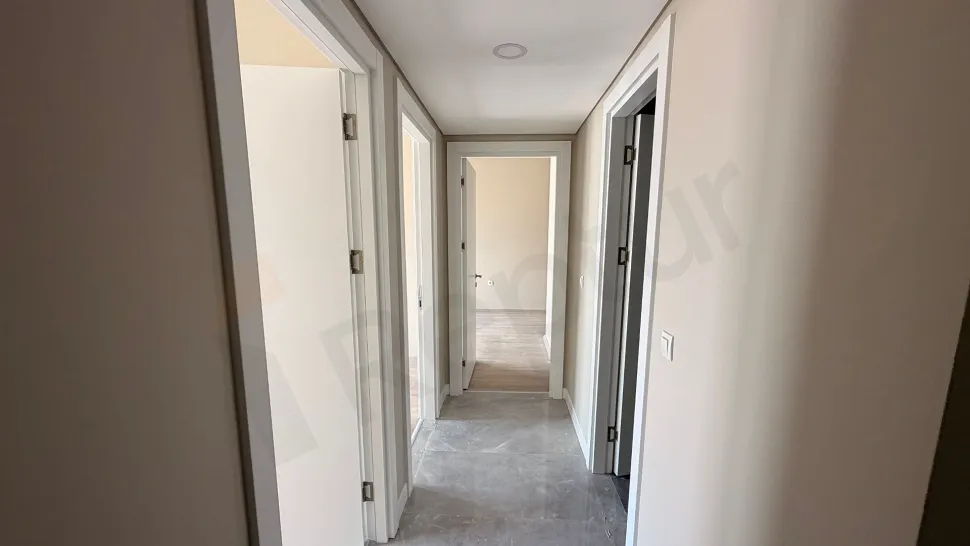 Spacious and bright interior corridor view of a modern residence building.