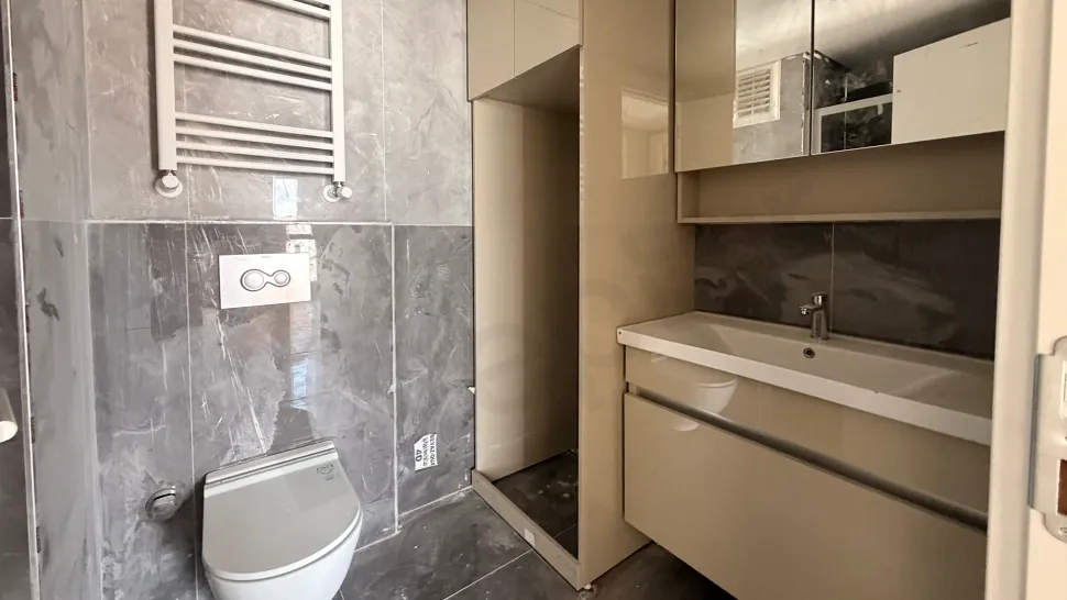 A bright residence bathroom with modern design and stylish ceramic tiles.
