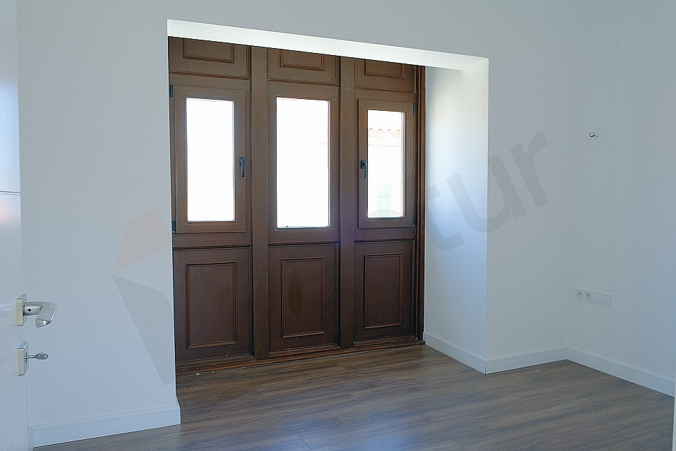 Bedroom image. Details of bed, nightstand and lighting.