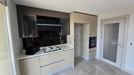 General view of a modern and spacious apartment kitchen.