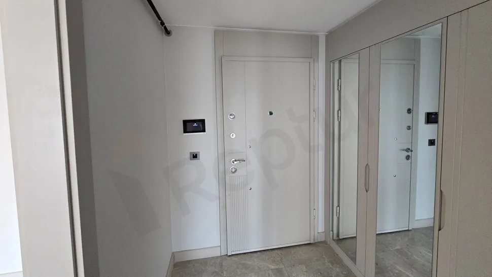 Spacious and bright apartment entrance and hallway area in a modern building.