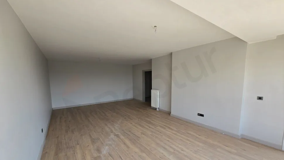 Spacious and bright luxury living room interior with modern architectural design and large windows.