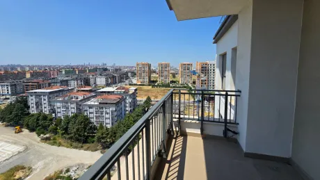 View of a spacious and airy modern apartment balcony.