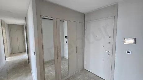 The entrance door and spacious hallway area of a modern apartment.