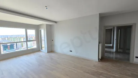 Spacious and bright living room area of a modern 3+1 apartment with large windows.