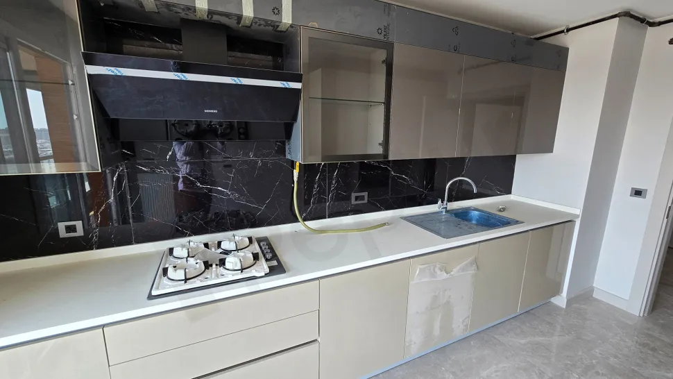 Modern and spacious kitchen area of a newly built duplex apartment.