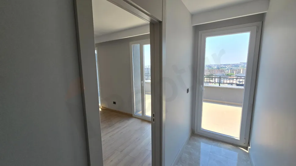 Spacious and modern interior design view of a bedroom.