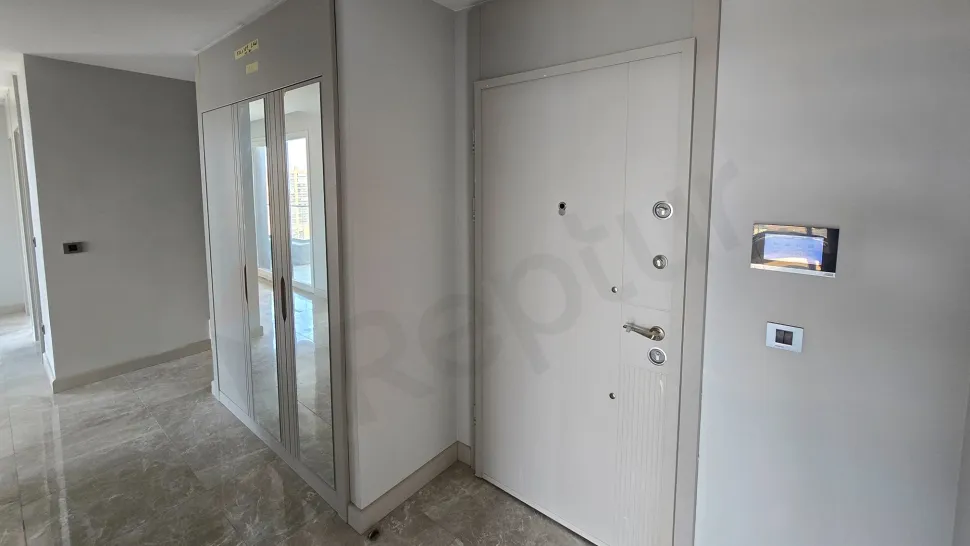 Entrance door and hallway area of a luxury apartment in a modern building.