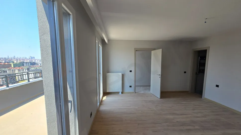 View of a spacious and bright bedroom with modern architectural details.
