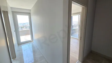 Spacious and modern bedroom interior with natural light.