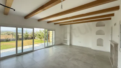 Spacious and bright living room interior with modern architecture and large windows.