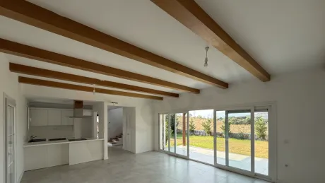 Spacious and bright living room interior of a modern villa with natural light.