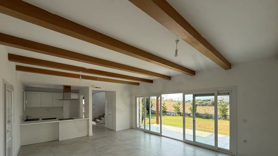 Spacious and bright living room interior of a modern villa with natural light.