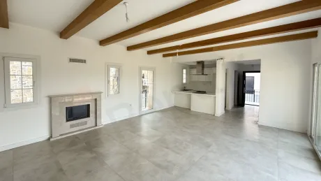 Bright and spacious villa living room area with modern architecture and large windows.
