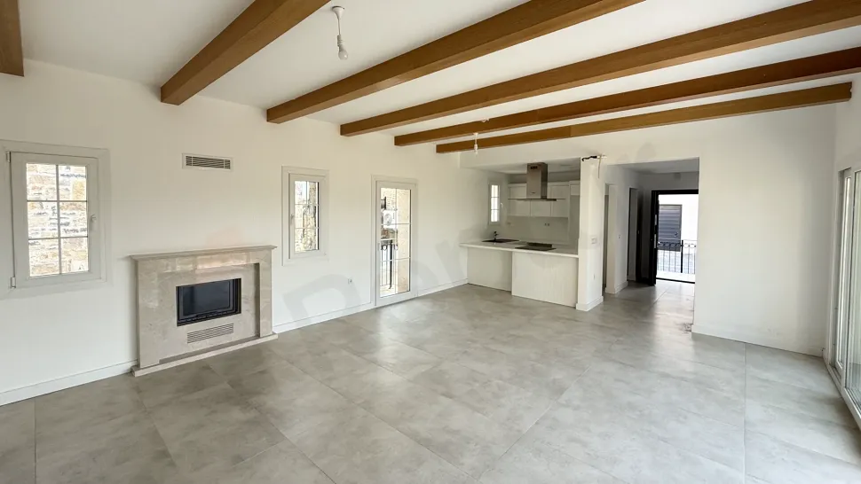 Bright and spacious villa living room area with modern architecture and large windows.