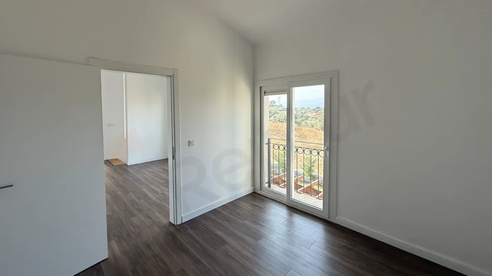 Modern and spacious villa bedroom interior view with large windows.