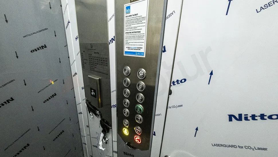Interior and exterior view of a modern, stylish elevator in a contemporary building.