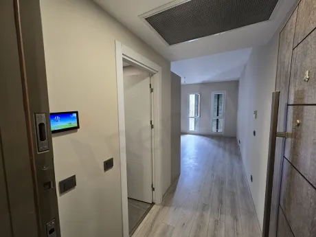 Entrance door and hallway of a modern apartment unit.