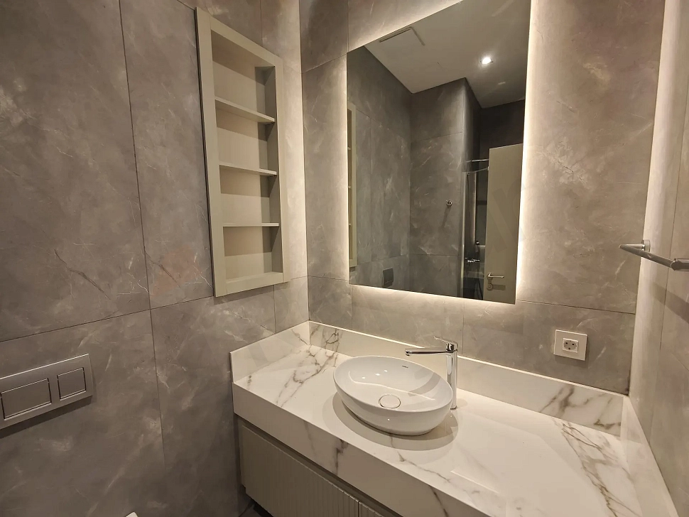 Modern designed, spacious and bright bathroom area.
