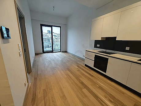 Modern living room area with large windows and city views in Sisli, Istanbul.
