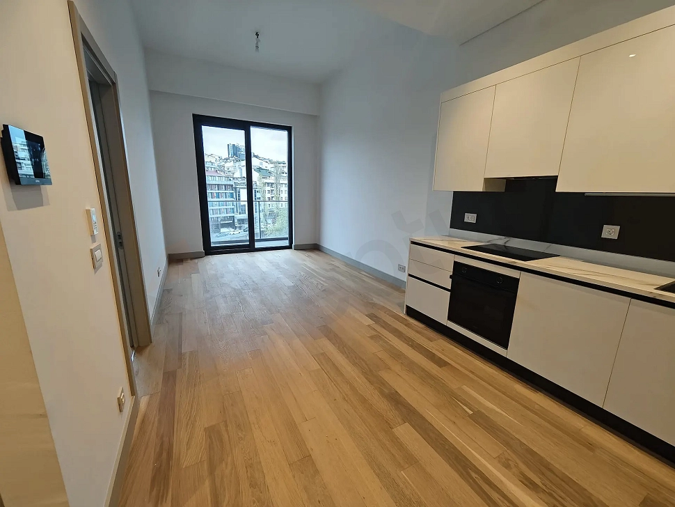 Modern living room area with large windows and city views in Sisli, Istanbul.