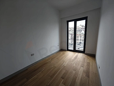 View of a bright and spacious bedroom in a modern residence apartment.