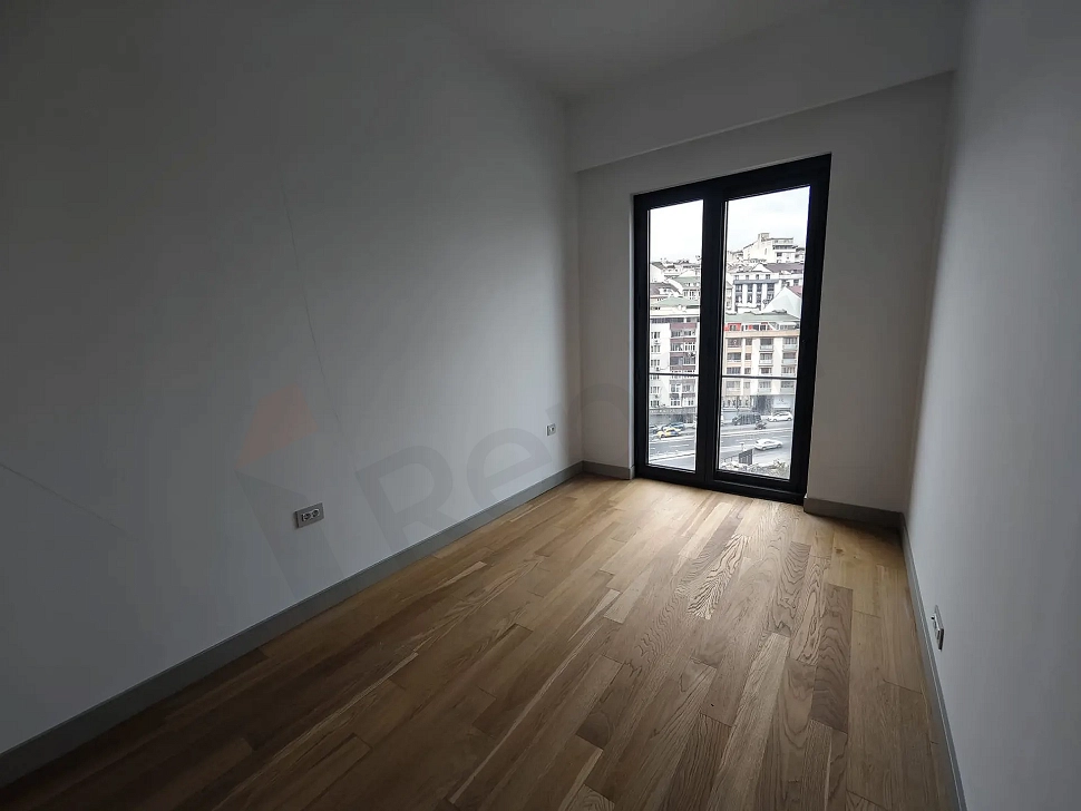View of a bright and spacious bedroom in a modern residence apartment.