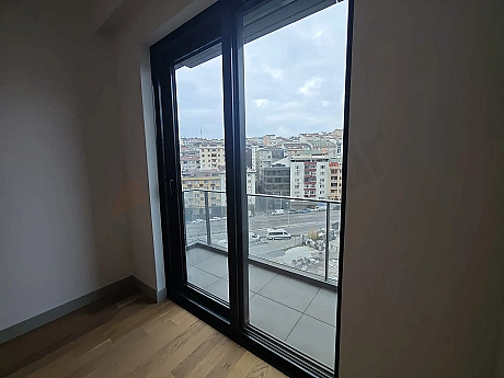 A spacious and modern balcony of a residence apartment in Sisli opening to a city view.