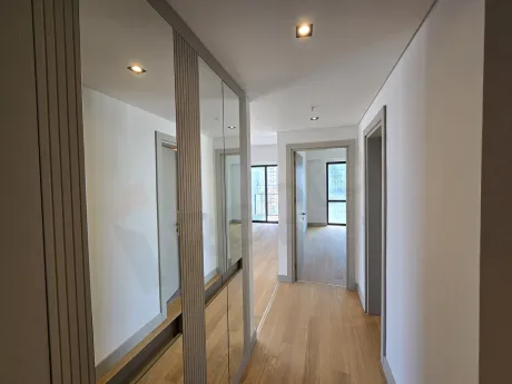 Detail of the entrance door and hallway of a modern apartment.