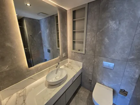 Modern bathroom interior design with stylish tiles and sink area.