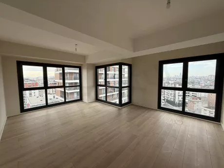Spacious and bright living room of a modern apartment with natural light.