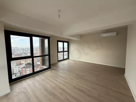 Spacious and bright living room area with large windows and modern design.