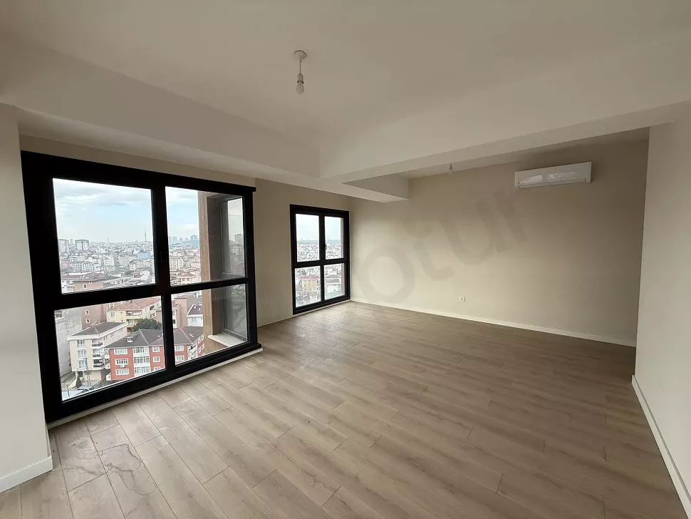 Spacious and bright living room area with large windows and modern design.