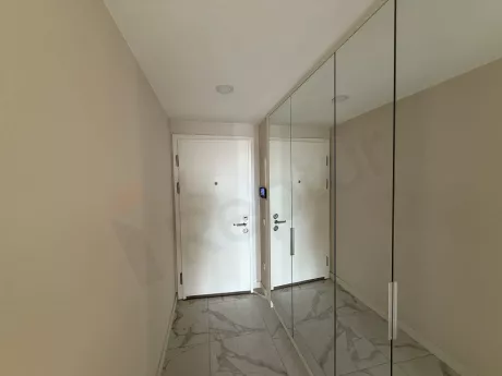 Spacious entrance hall and front door view of a modern apartment.