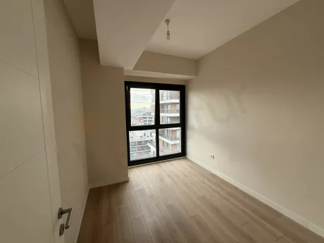 Spacious and modern bedroom with natural sunlight in an Istanbul Cekmekoy apartment.