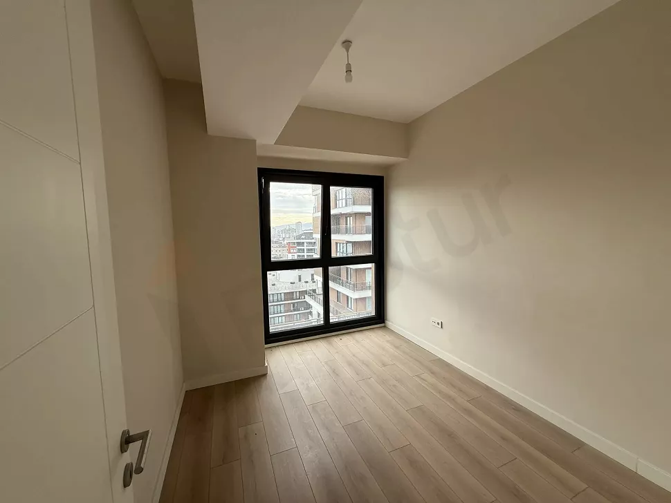 Spacious and modern bedroom with natural sunlight in an Istanbul Cekmekoy apartment.