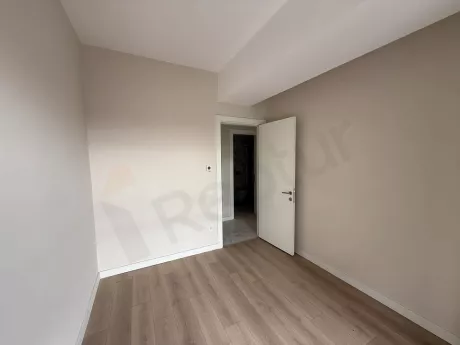 Bright and spacious empty bedroom interior with a modern design and large windows.