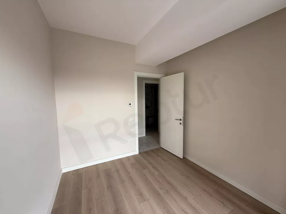 Bright and spacious empty bedroom interior with a modern design and large windows.