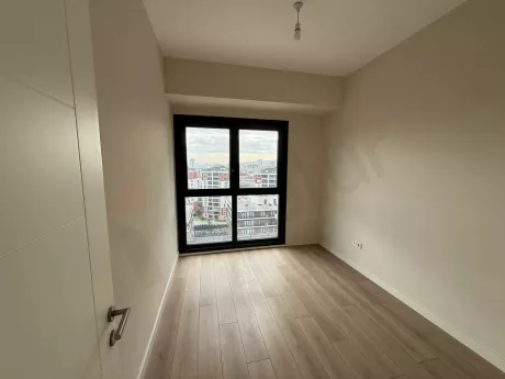 A spacious and bright bedroom area with modern architectural design and natural light.