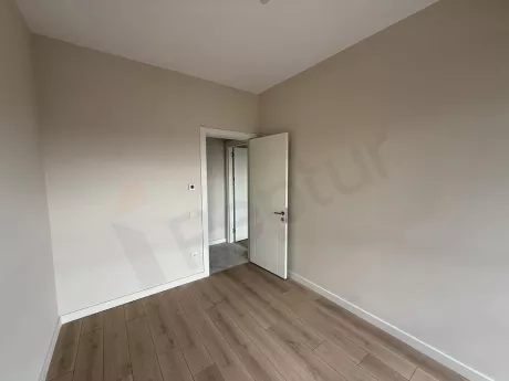 A spacious and bright bedroom with modern design and natural light.