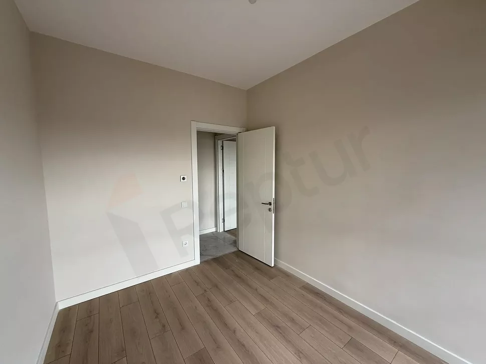 A spacious and bright bedroom with modern design and natural light.