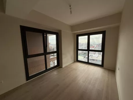Spacious and sunlit modern bedroom of a 3+1 apartment for sale in Cekmekoy.