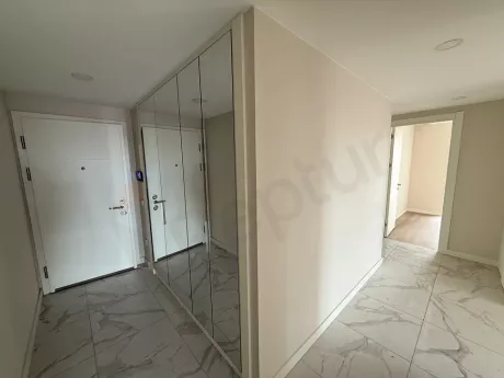 Entrance door and hallway area of a 3+1 apartment in a modern building.