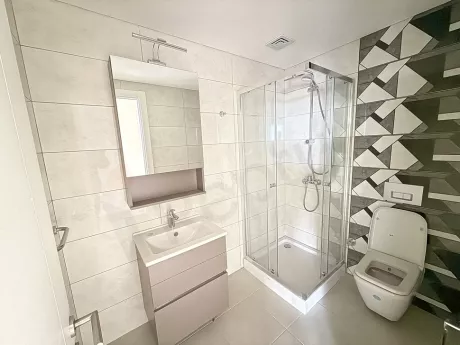 Modern bathroom design with stylish ceramic tiles and contemporary plumbing fixtures.