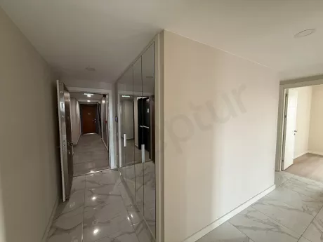 View of the entrance door and hallway area of a modern apartment.