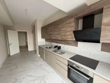 Modern designed spacious kitchen area, kitchen cabinets, and countertop detail.